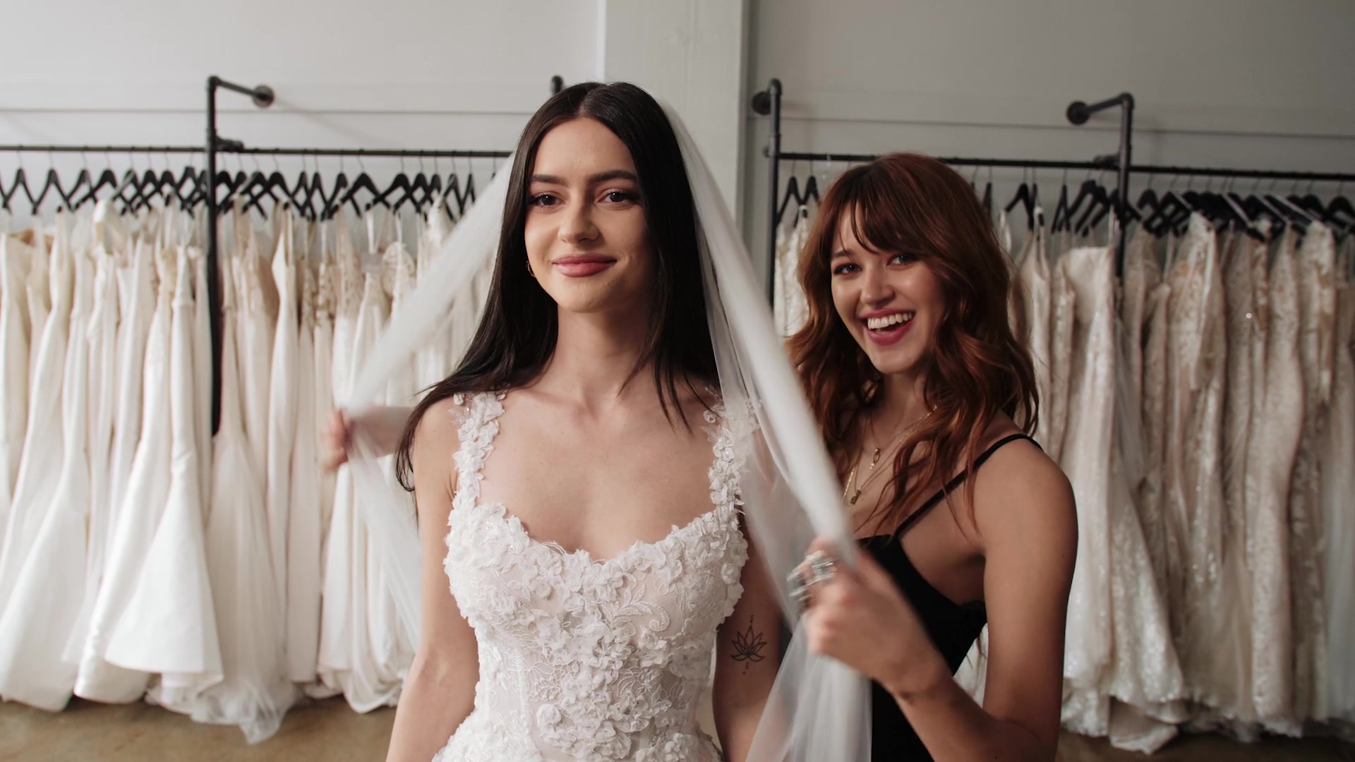 Bride in her veil with smiling friend