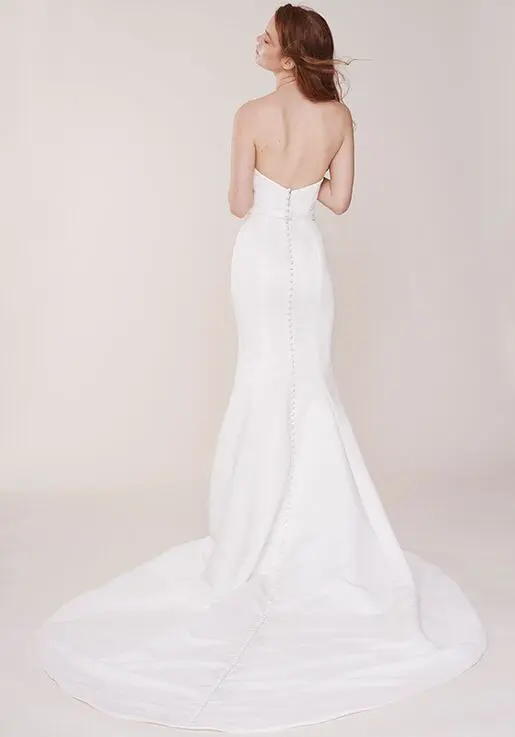 1627409652594-windsor-back Windsor, an ivory matte satin strapless mermaid wedding gown with a flattering, fitted silhouette, featuring a deep-V neckline, a long row of delicate buttons cascading down the back, and a chapel train.