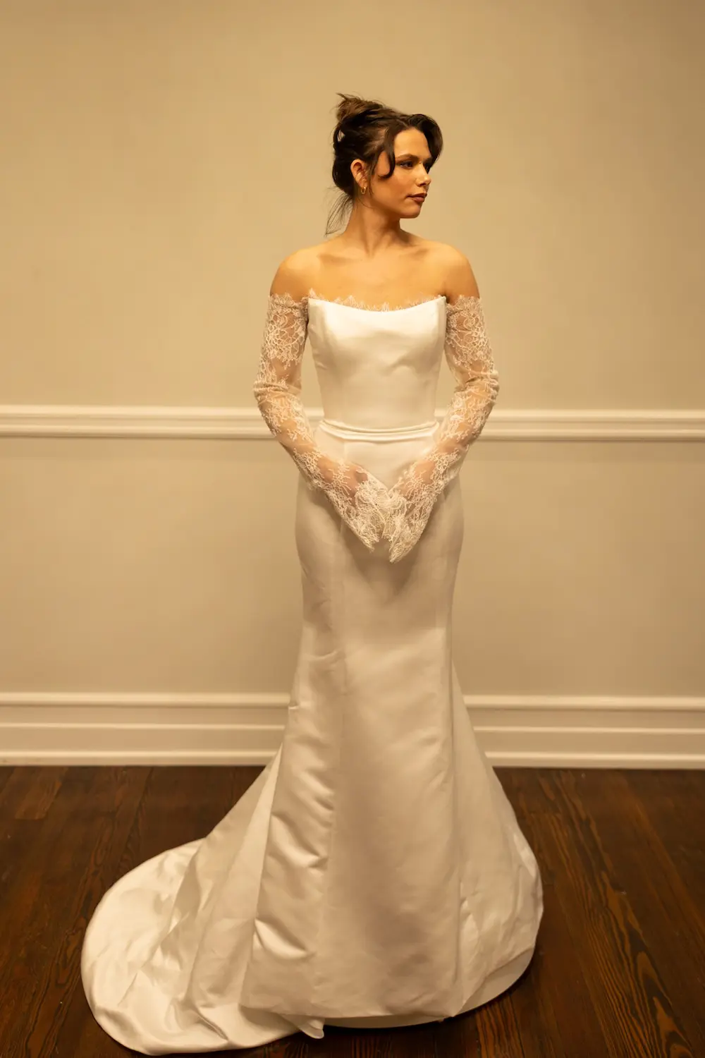 Madison, an ivory mermaid bridal gown by Sincerely Adorn, size 12, featuring a strapless satin bodice, elegant off-the-shoulder long lace sleeves, and a chapel train.