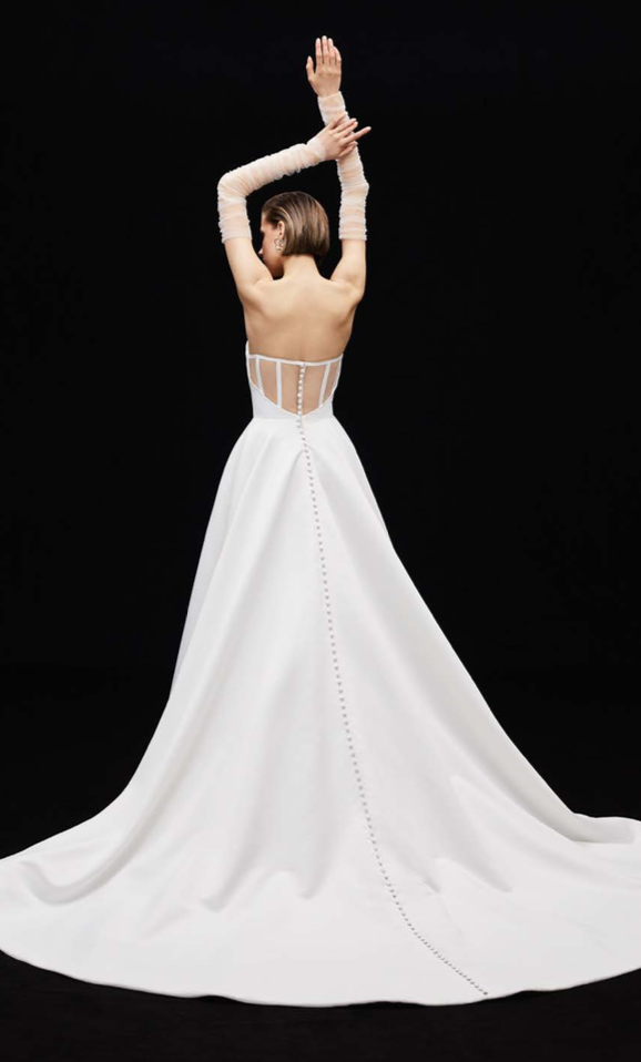 uploads-1659120069579-Screen+Shot+2022-07-29+at+2.40.20+PM Stella - This exquisite A-line gown, made from luxurious matte satin, features a deep sweetheart neckline that beautifully frames the décolletage.