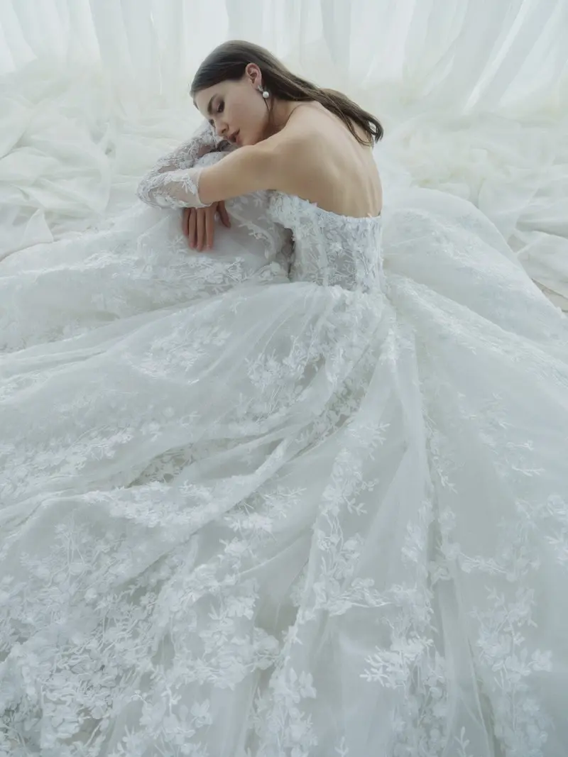 uploads-1766173116376-aPp0V7pReVYa3n7c_5512_WHISPER_FW26_RV_RIVINI_C_WEB-1- Dimensional organza floral lace ballgown wedding dress