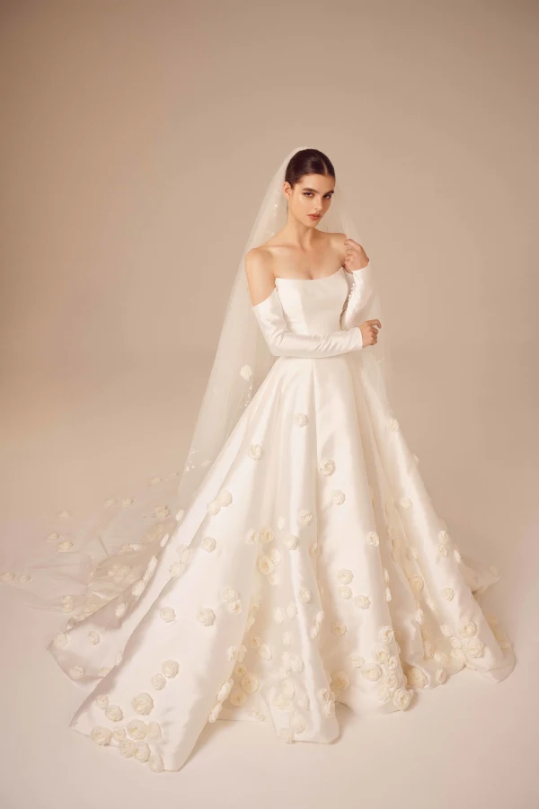 1723578294187-dewz36hfvrbzfbuvnkd5-5 NF035, a Light Ivory A-line bridal gown crafted from luxurious Mikado fabric, featuring a strapless scoop neckline with delicate off-the-shoulder 3/4 sleeves and intricately placed 3D floral appliqués throughout the design. Nicole + Felicia.