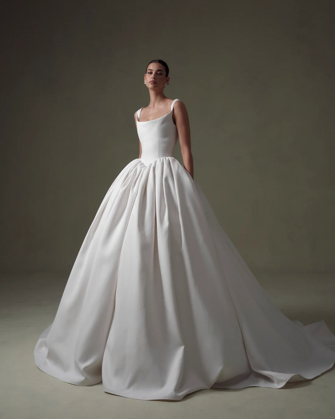 1745434593452-20250313NF4901 SE067, an ivory matte Mikado ball gown, features a modern basque waist, a structured scoop neck bodice with elegant straps, and a full skirt with a chapel train, creating a clean, regal, and dramatic bridal look.
