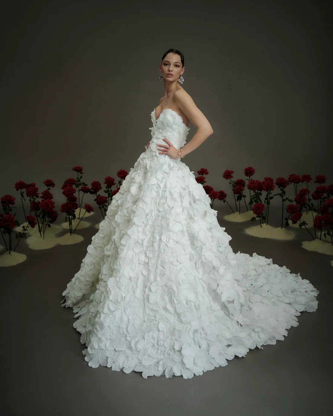1748022927678-NF1955-1 NF114, a Light Ivory strapless V-neck ballgown with a bodice and full skirt adorned with textured 3D floral petals, extending into a dramatic cathedral-length train.