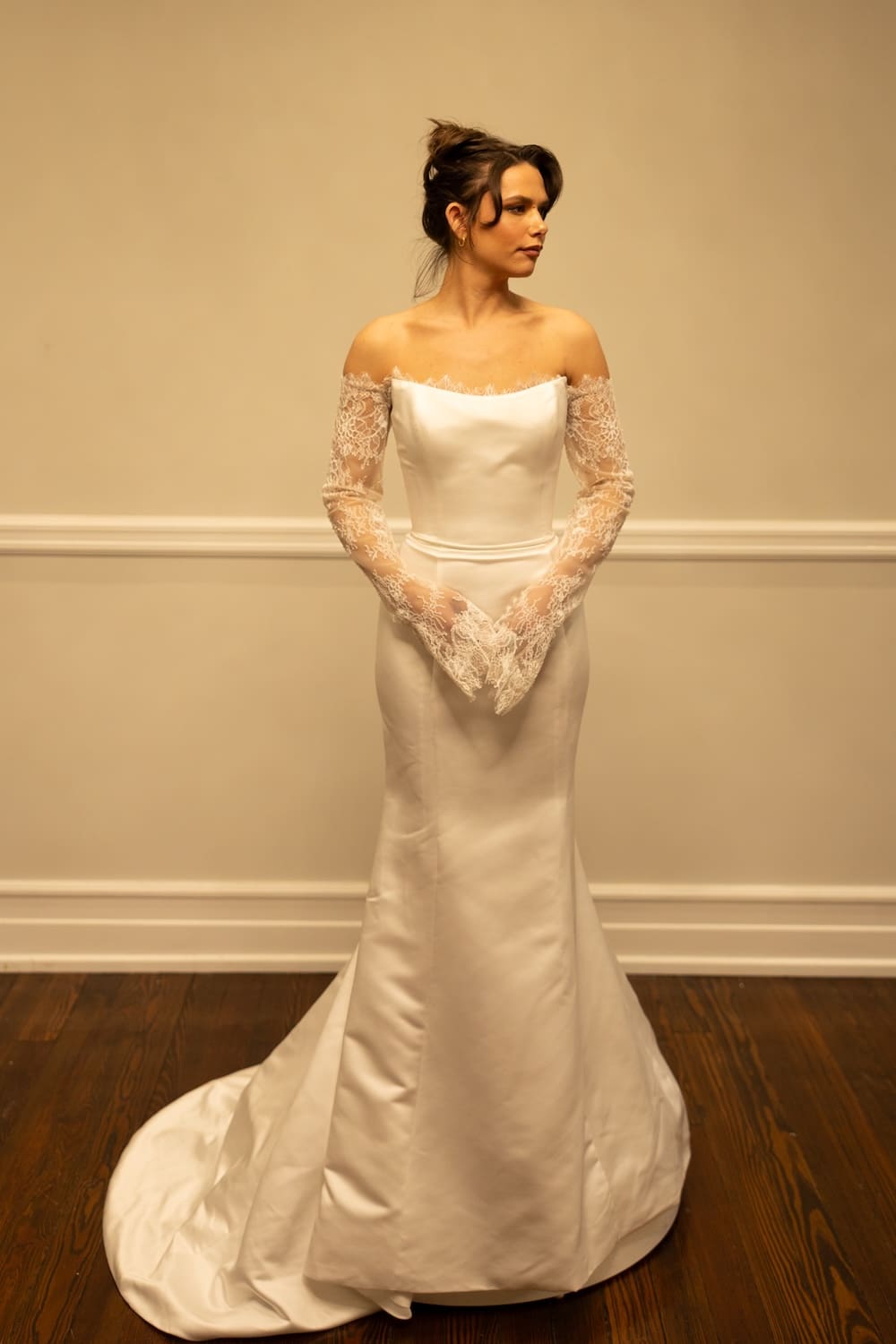 Madison, an ivory mermaid bridal gown by Sincerely Adorn, size 12, featuring a strapless satin bodice, elegant off-the-shoulder long lace sleeves, and a chapel train.